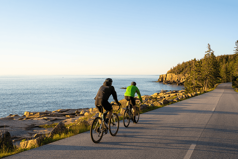 Two bike riders enjoying their ride along the Maine coast.