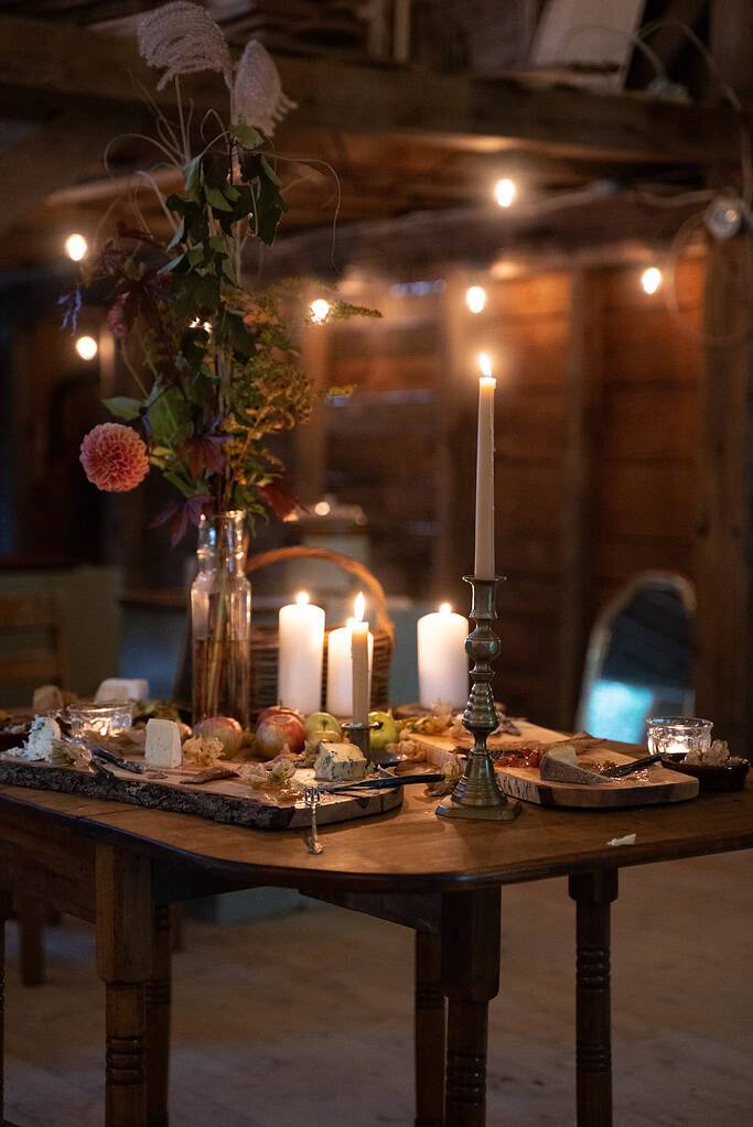 rustic wooden table with candles and apples on the table