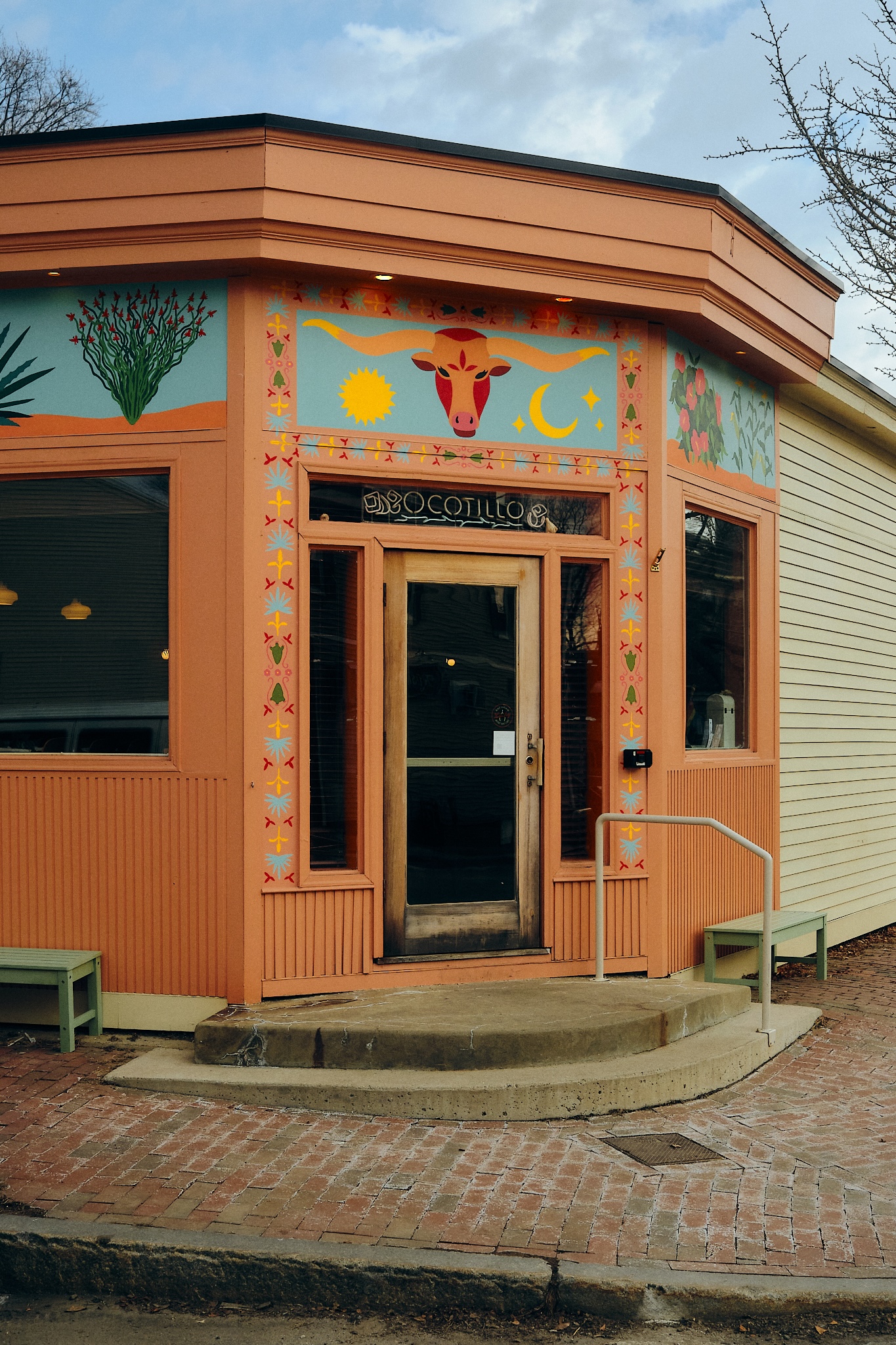 exterior of a bright terracotta corner restaurant