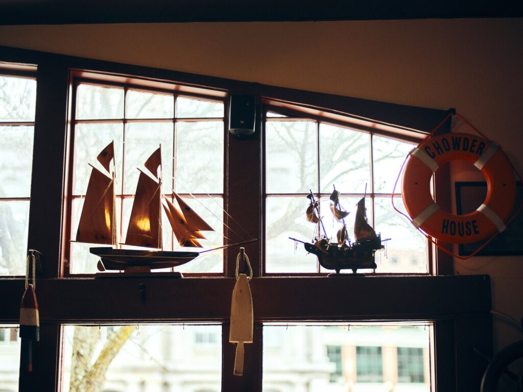 miniature wooden sailboats in a window