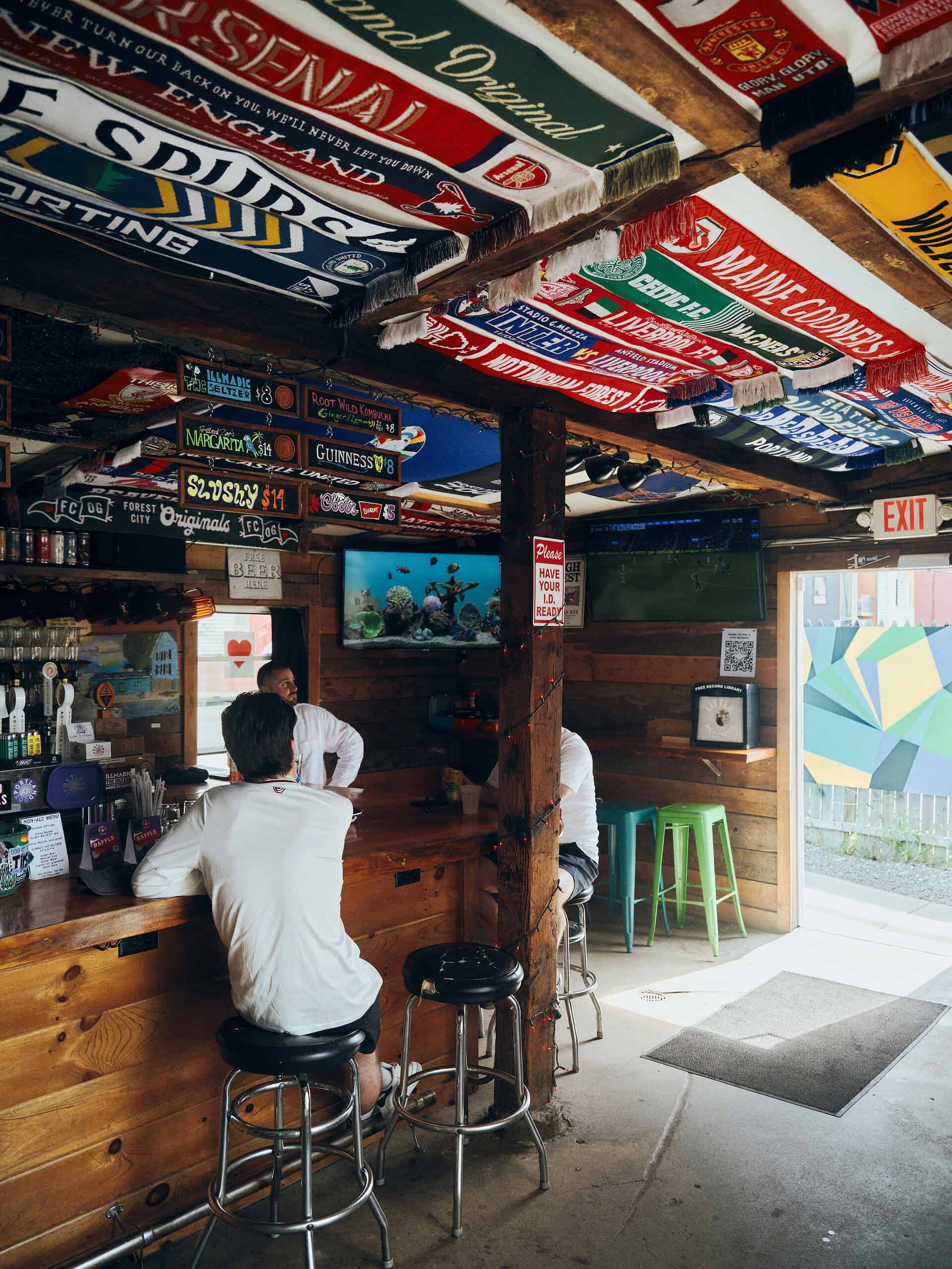person sitting at bar watching sports